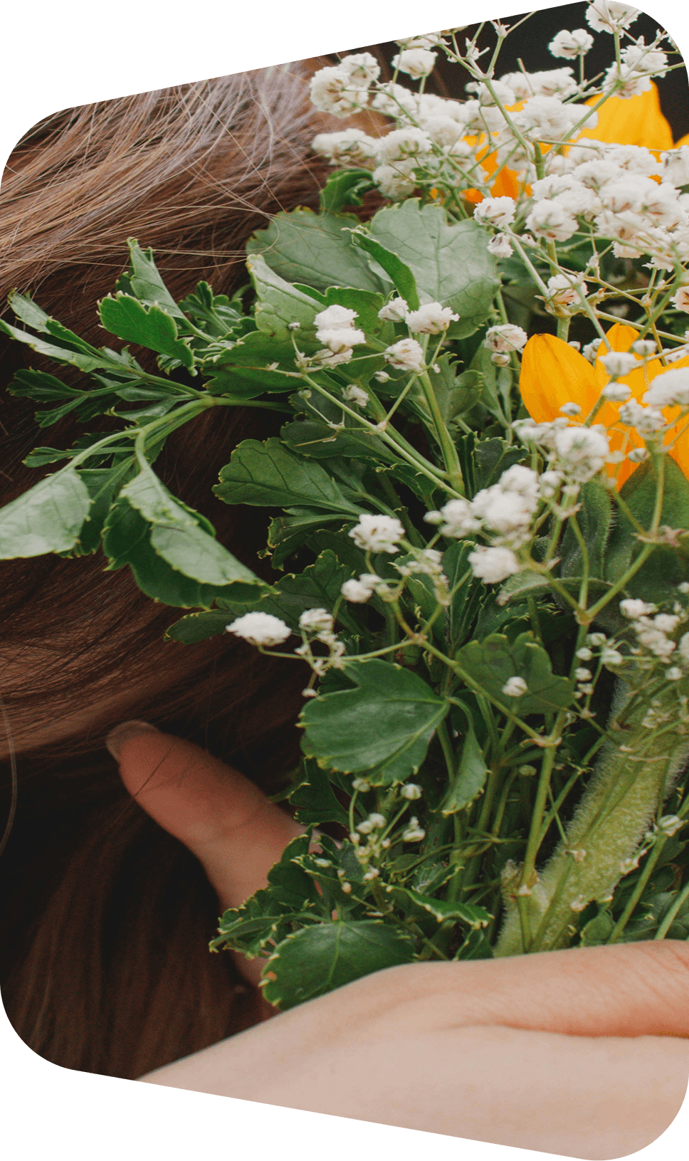 Hands holding a bouquet of wildflowers